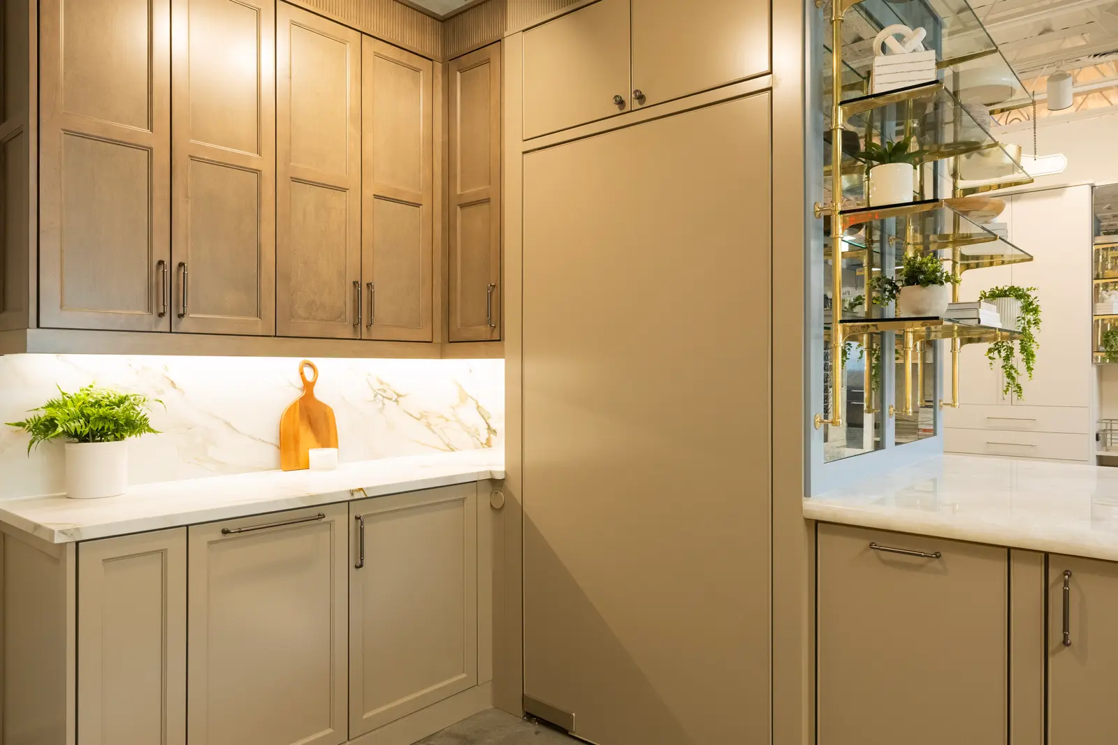 Warm oak cabinetry and brass shelving in the Oprea showroom